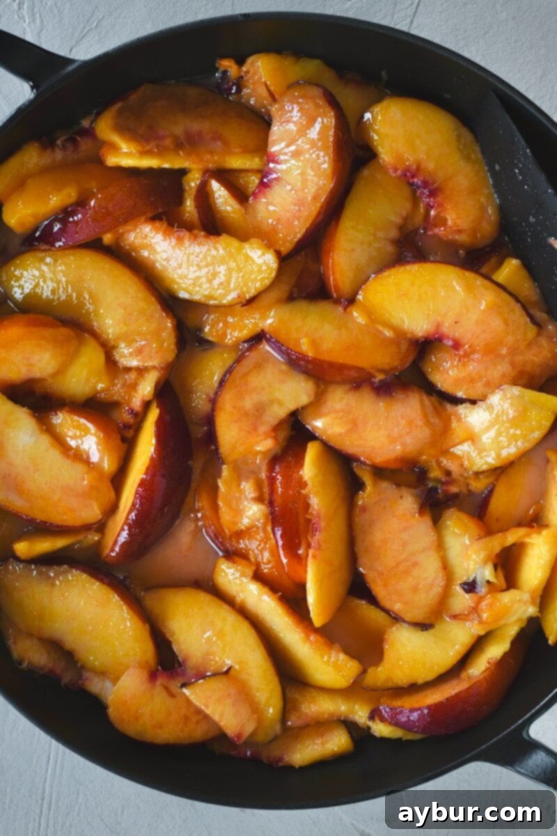 Succulent sliced peaches, perfectly coated with sugar and cornstarch, settled in the baking dish.
