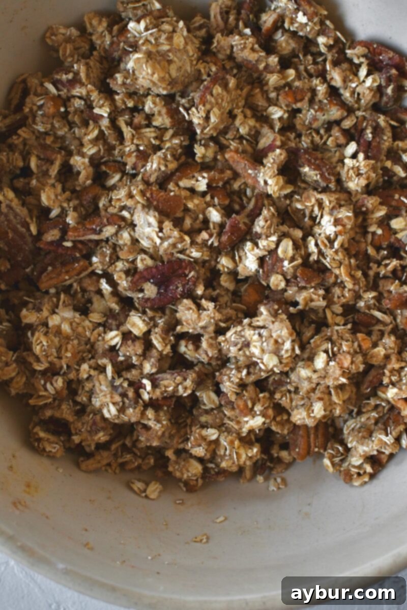 The oat, brown sugar, pecan, and butter mixture perfectly combined in the bowl, ready for the peaches.