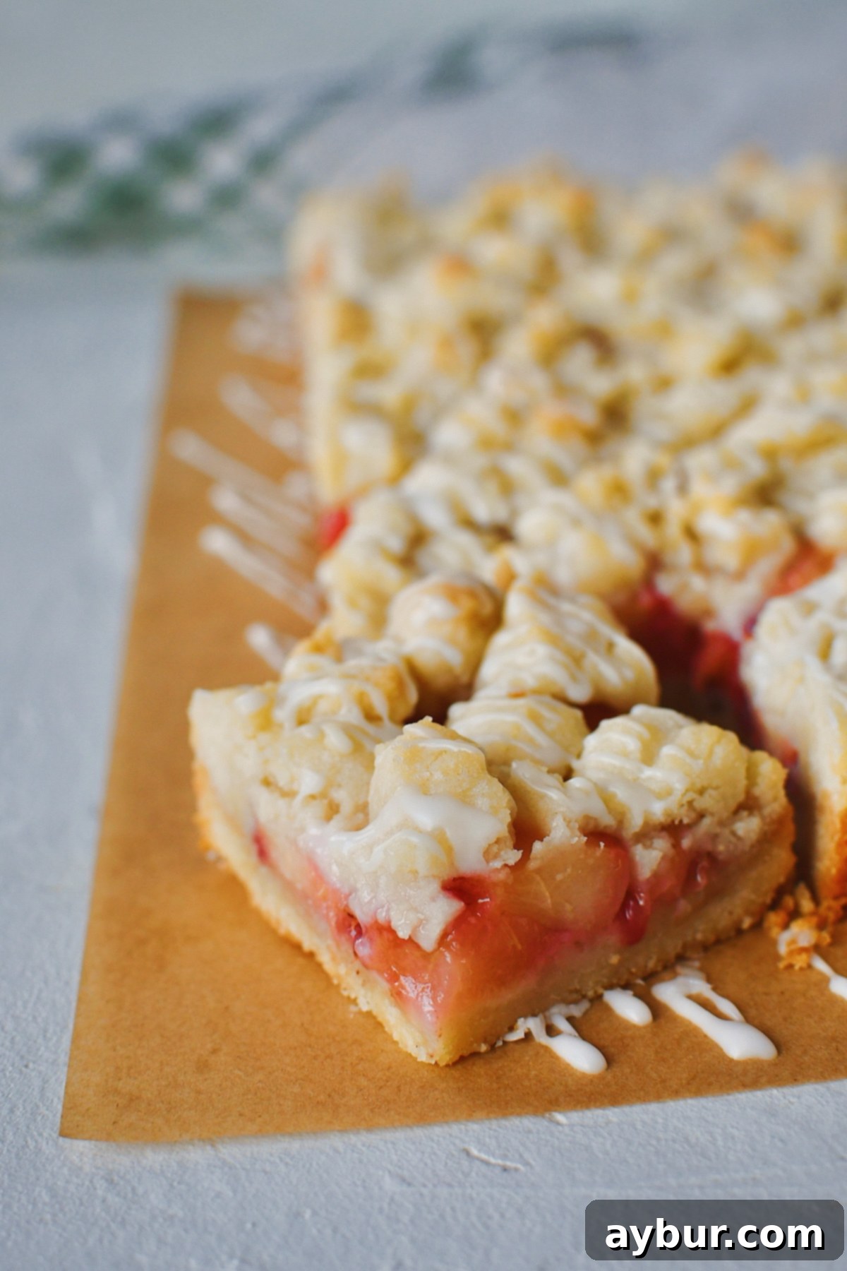 Side view of sliced White Peach Bars, revealing layers of shortbread, peach filling, and crumble topping.