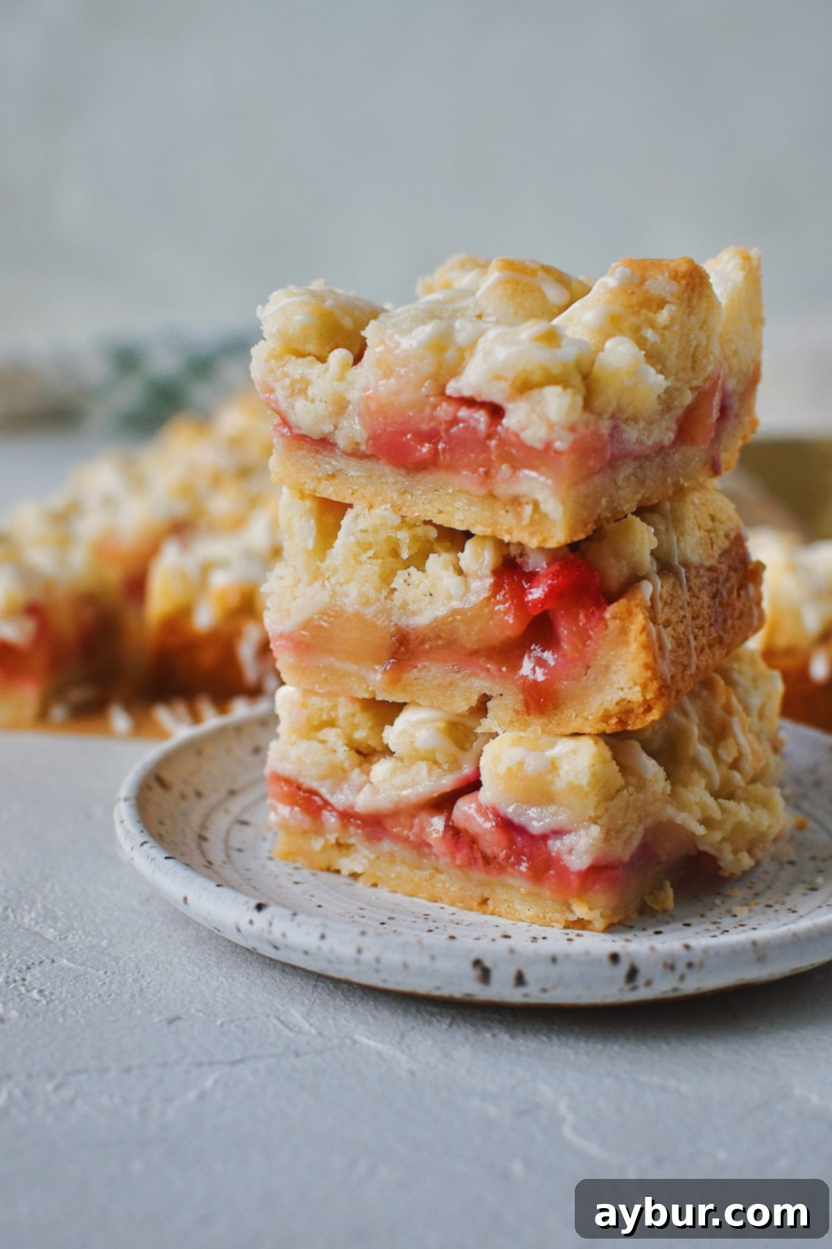 Three White Peach Bars stacked on a white plate, showing the layers.