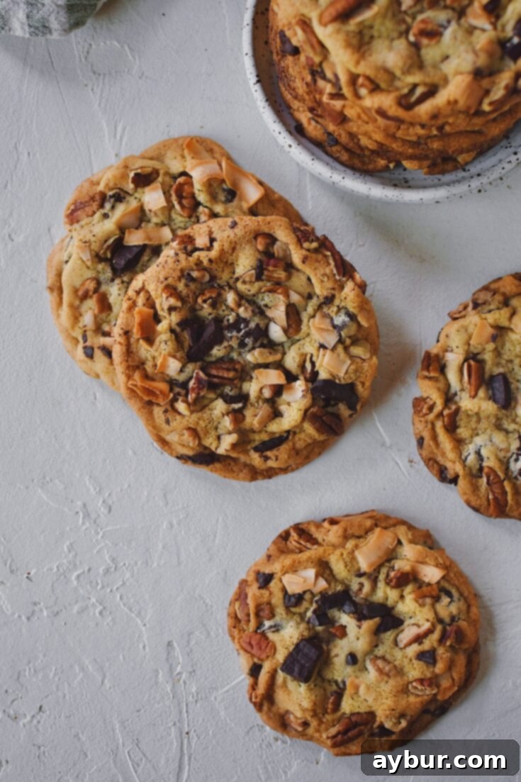 Delicious Coconut Pecan Chocolate Chip Cookies lying on a table, their golden edges and melted chocolate tempting to the eye.