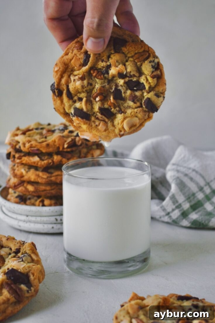 Pinterest pin showing Coconut Pecan Chocolate Chip Cookies ready to be eaten with milk.