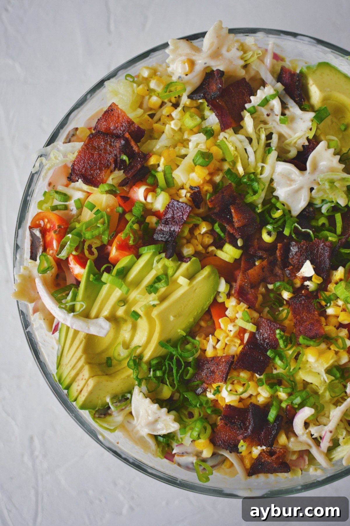 A close-up view of the BLT Pasta Salad, showcasing the rich texture and colorful ingredients, perfectly dressed and ready to be enjoyed.