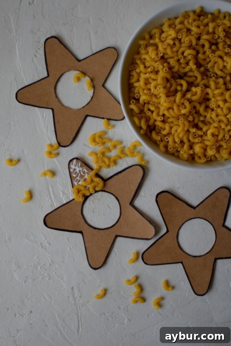 Cut out stars, with the middle cut out also, gluing macaroni noodles to them.