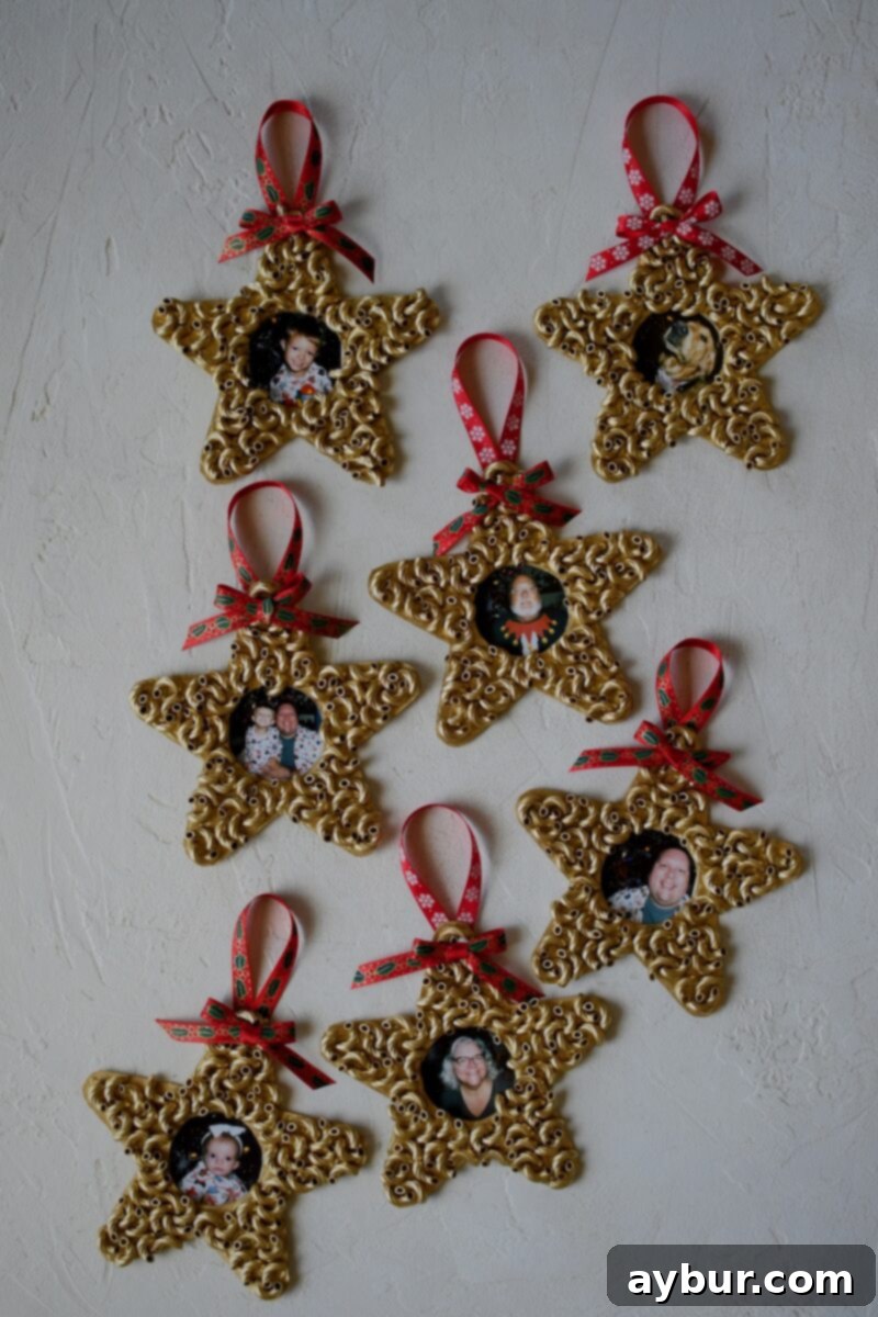 Pictures have been cut to size and glued to the back of the ornaments, and the easy pasta christmas ornaments are complete and ready to hang on the tree.