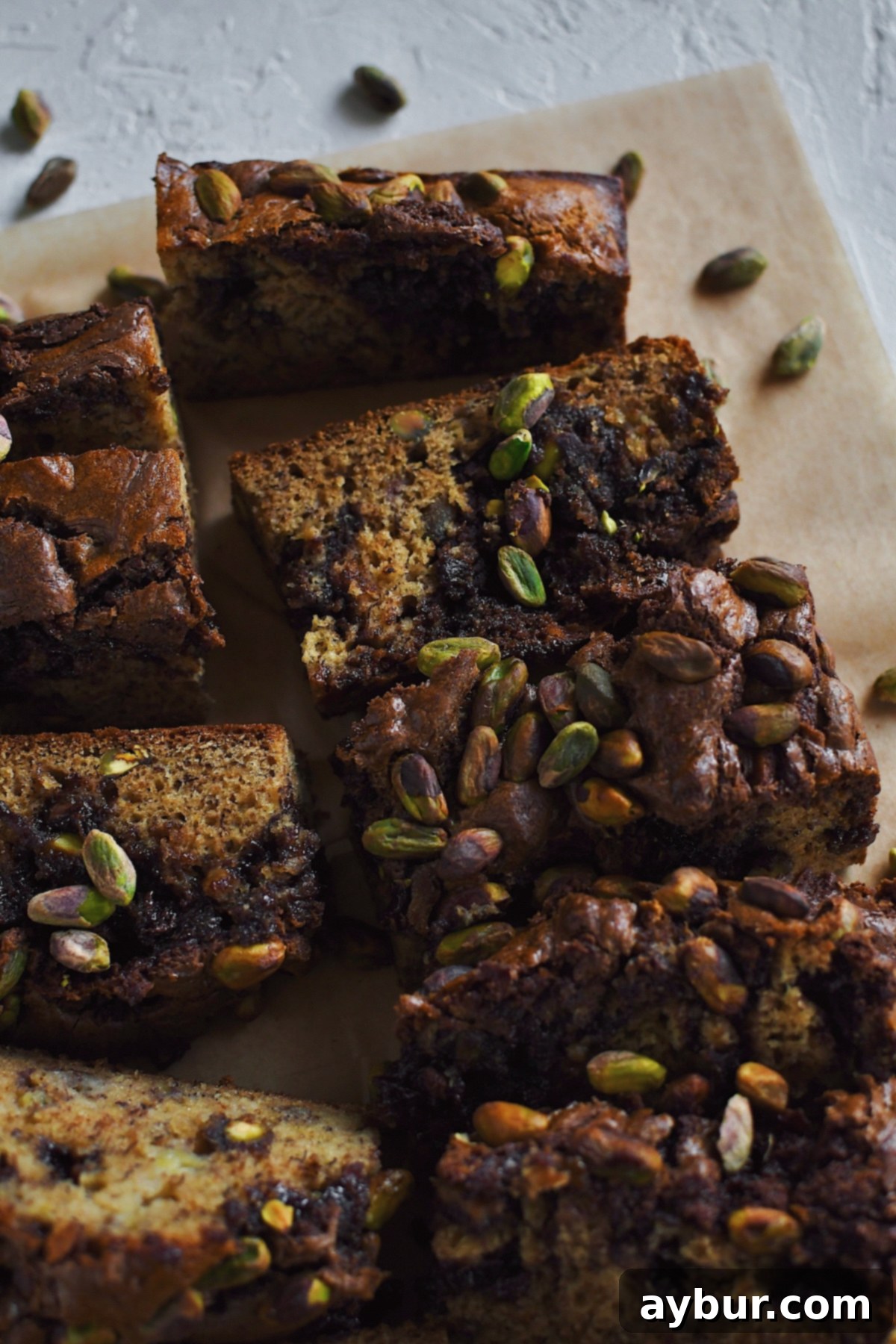 Looking into a sliced loaf of Dubai Chocolate inspired Banana Bread, studded with pistachios and swirled with nutella.