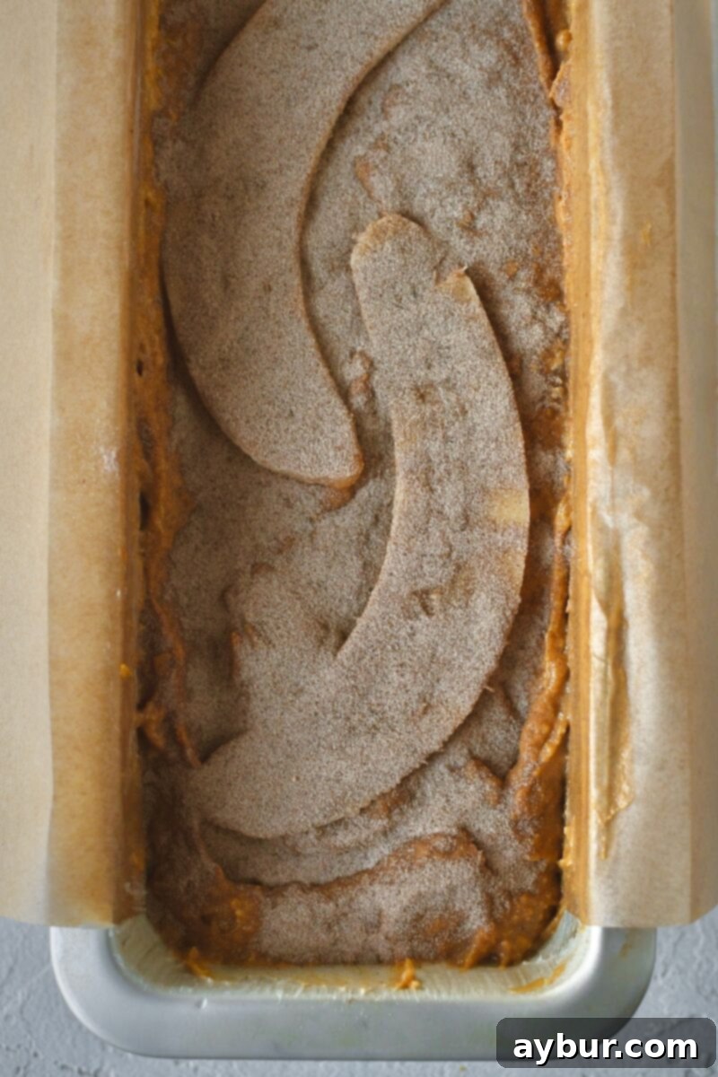 Batter and halved banana topped with cinnamon sugar before baking.