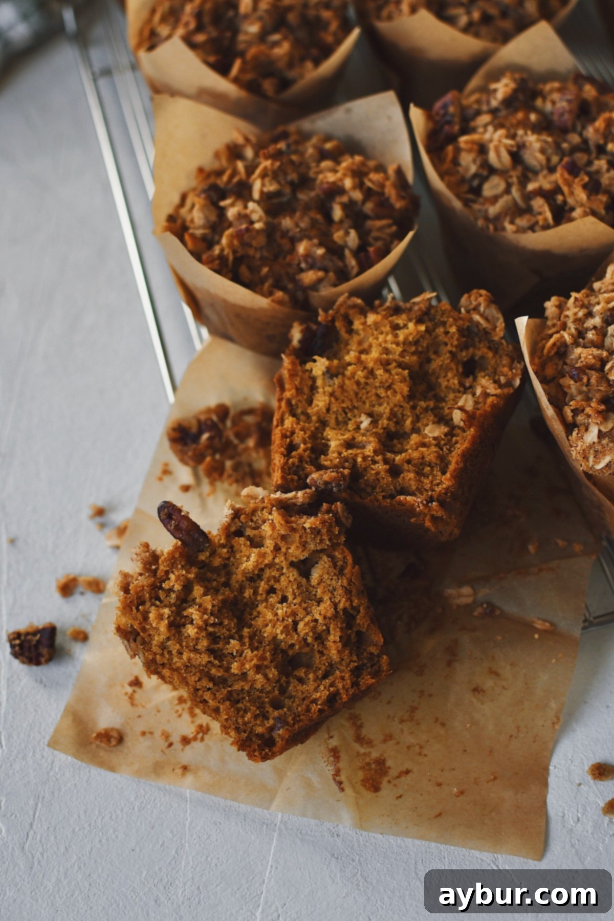 Pumpkin Banana Muffins with Pecan Streusel Topping 2 Delicious homemade Pumpkin Banana Muffin, split in half to reveal its moist, tender interior and topped with a golden pecan crisp.