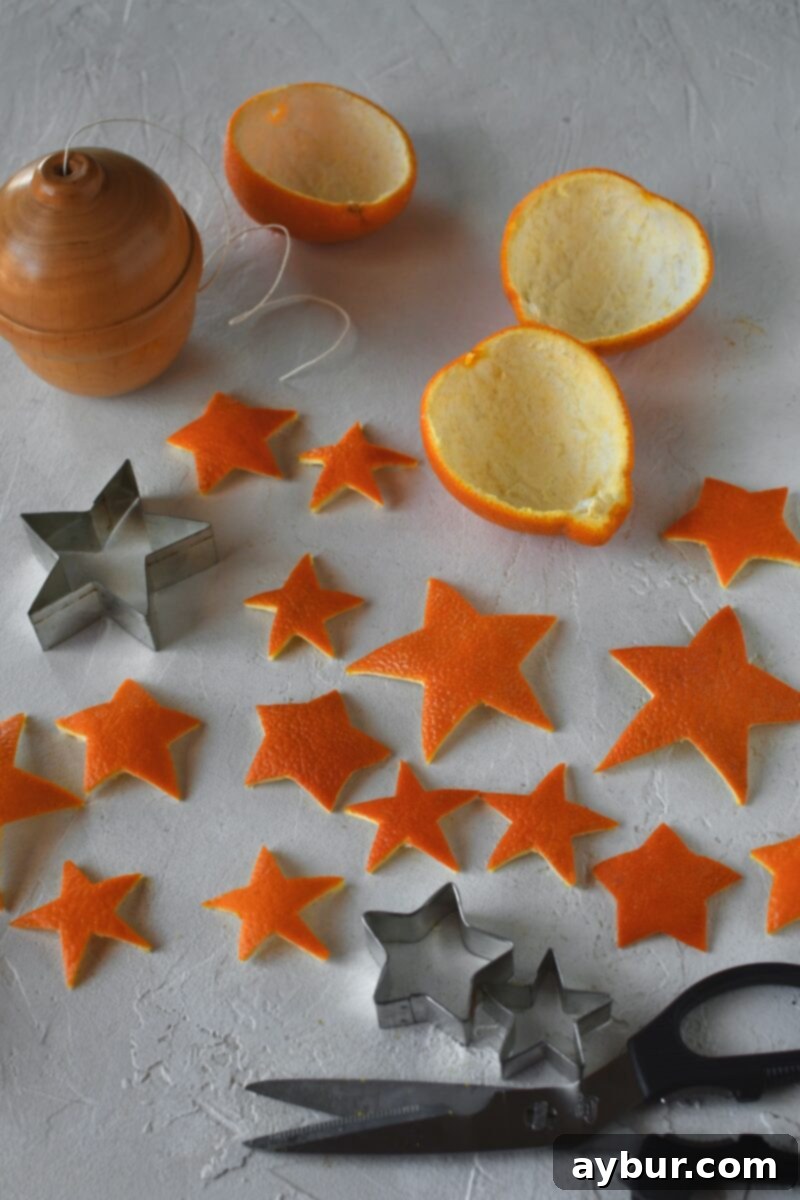 Fragrant Orange Star Garland 9 Neatly cut orange peel stars of various sizes arranged on a flat surface, showcasing the results of the cutting process.