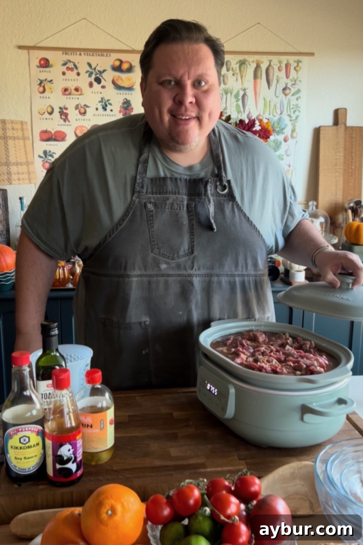 Kendell standing in his kitchen with the ingredients needed to make Slow Cooker Beef and Broccoli.