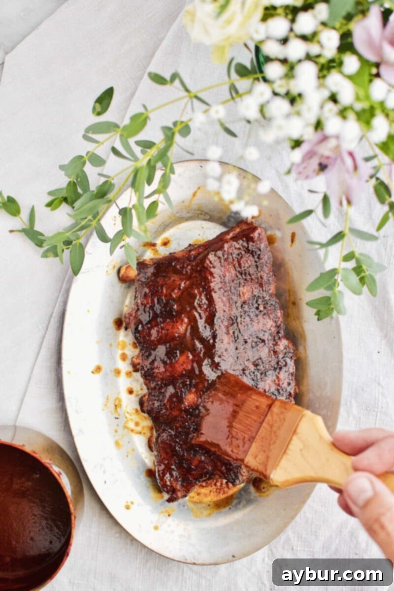 Tender Fall-Off-The-Bone Instant Pot BBQ Ribs 3 Close-up of sticky, glazed Instant Pot BBQ Ribs on the grill