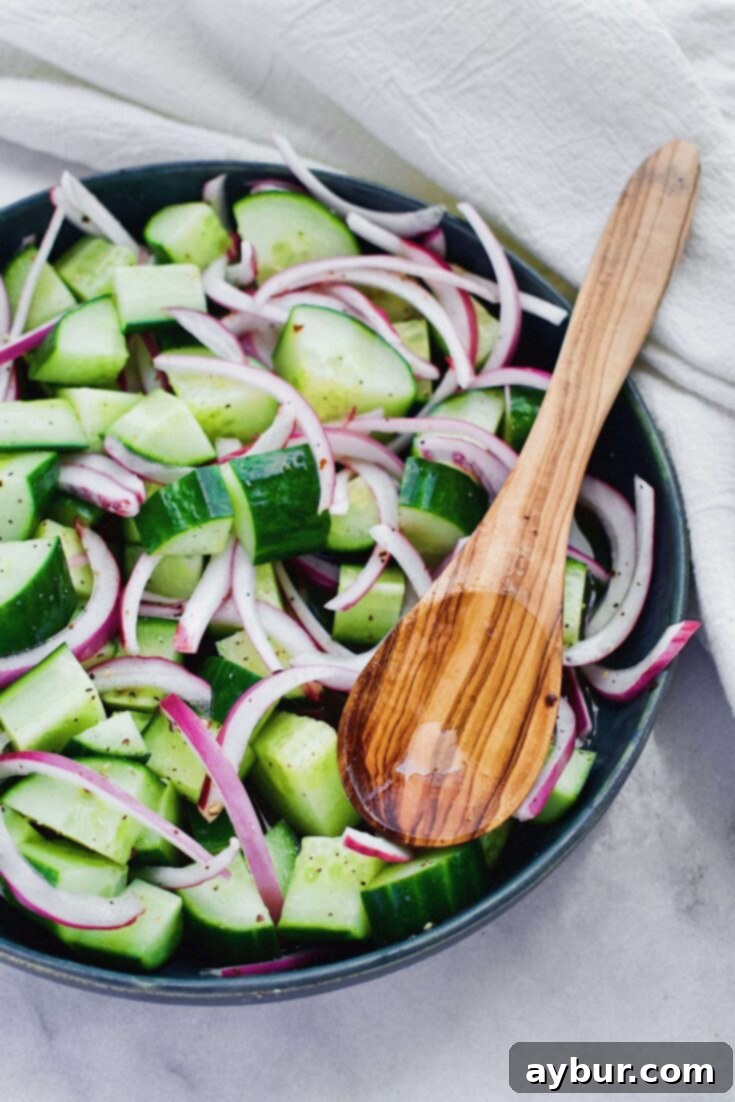 Instant Onion and Cucumber Pickles 5 Quick Pickled Cucumbers and Onions in a clear serving bowl, garnished with fresh herbs