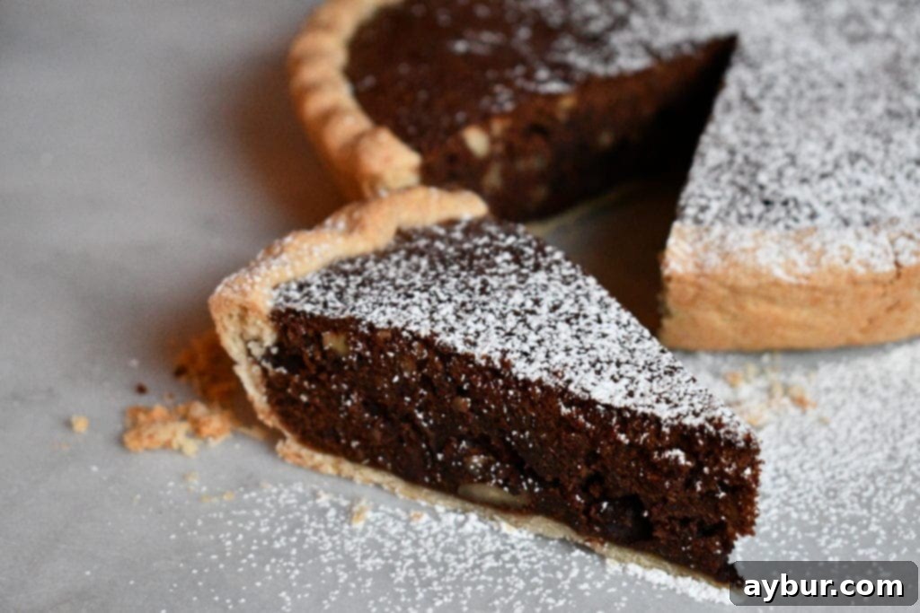 Close-up of a slice of Joanna Gaines brownie pie with a golden, flaky crust, ready to be served