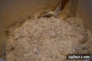 Mixing rice and condensed soup for the Baked Chicken with Bacon Bottom recipe