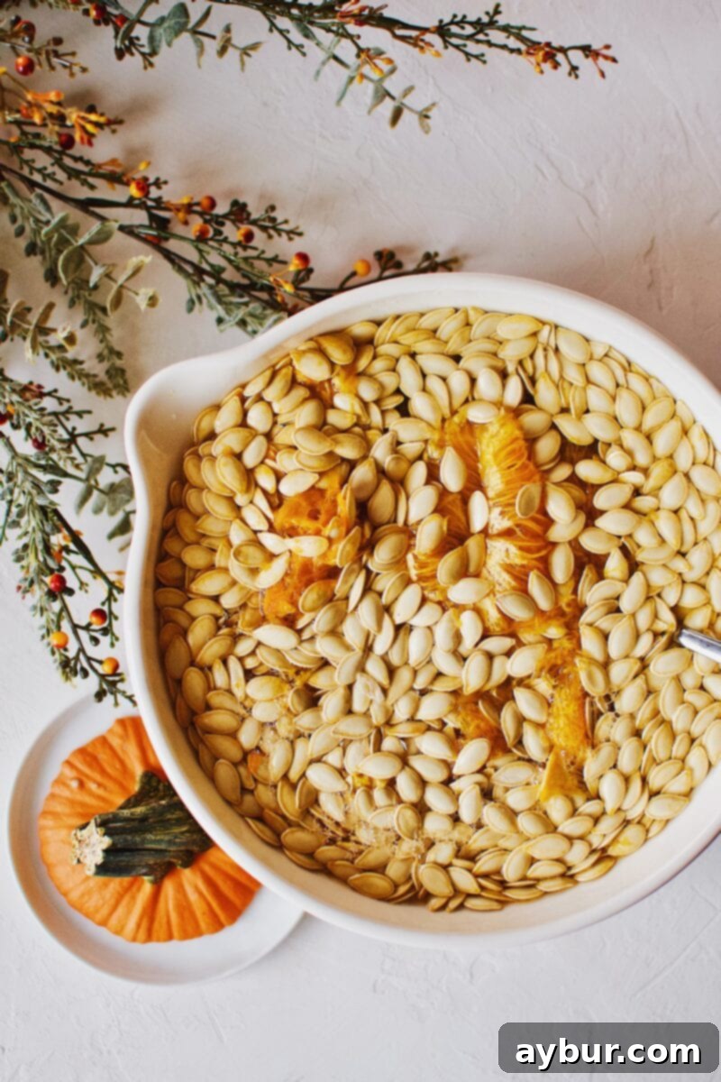 Soy-Glazed Pumpkin Seeds 4 Freshly scooped pumpkin seeds immersed in water to aid in the cleaning process, separating them from the pulp.