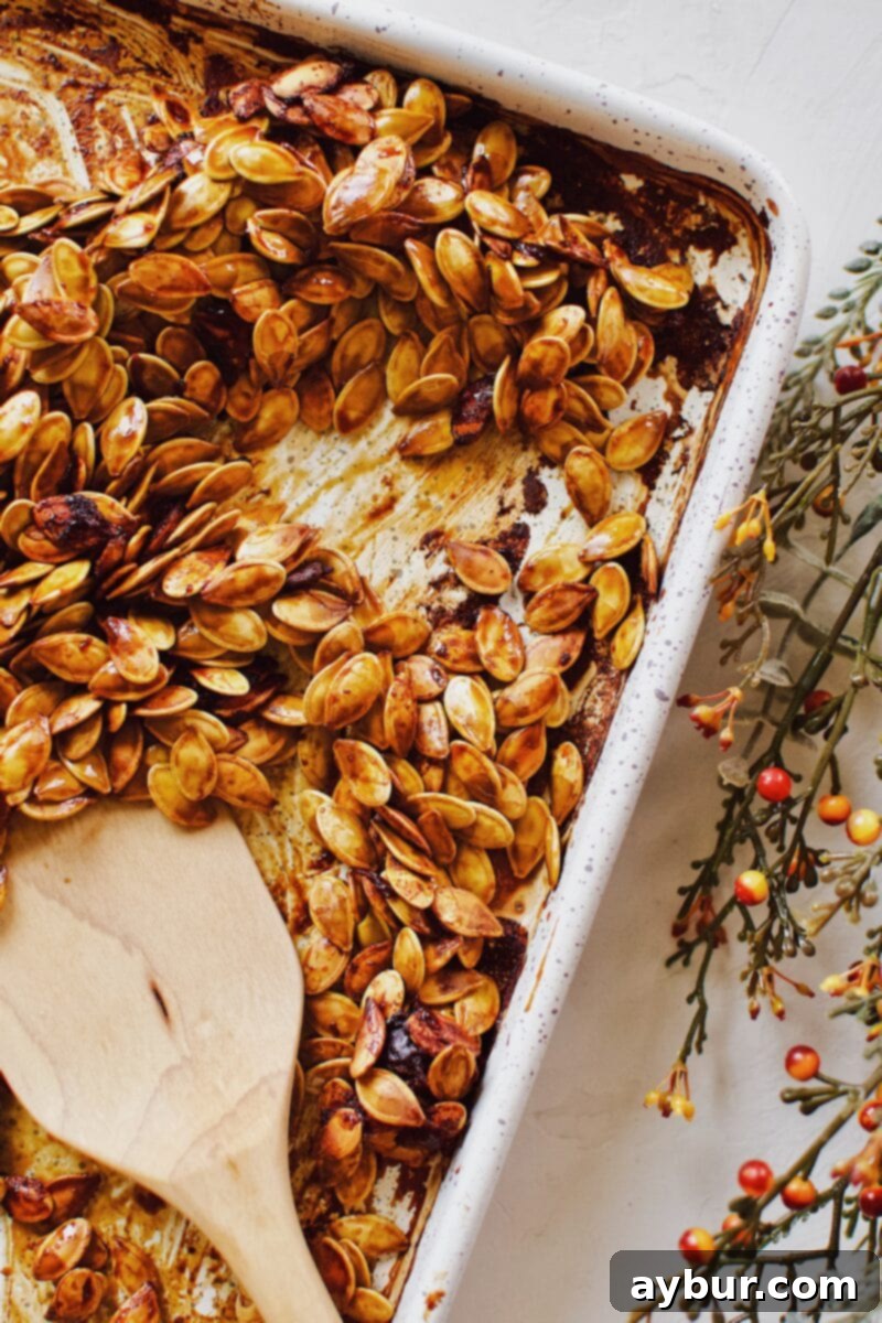 Soy-Glazed Pumpkin Seeds 8 Soy Sauce Pumpkin Seeds midway through the roasting process, showing some browning but still needing more time.
