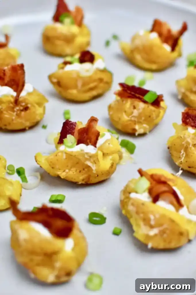 A tray of freshly prepared Loaded Baked Potato Bites, topped with melted white cheddar cheese and crispy bacon.