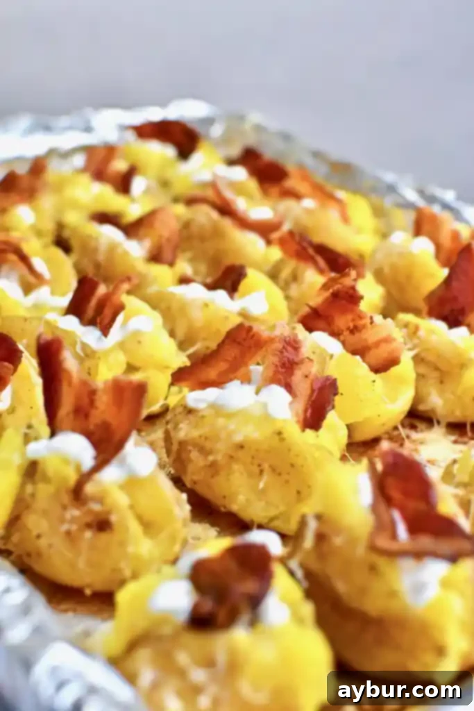 Bacon slices cooking on a baking sheet, ready to be crumbled for Loaded Baked Potato Bites.