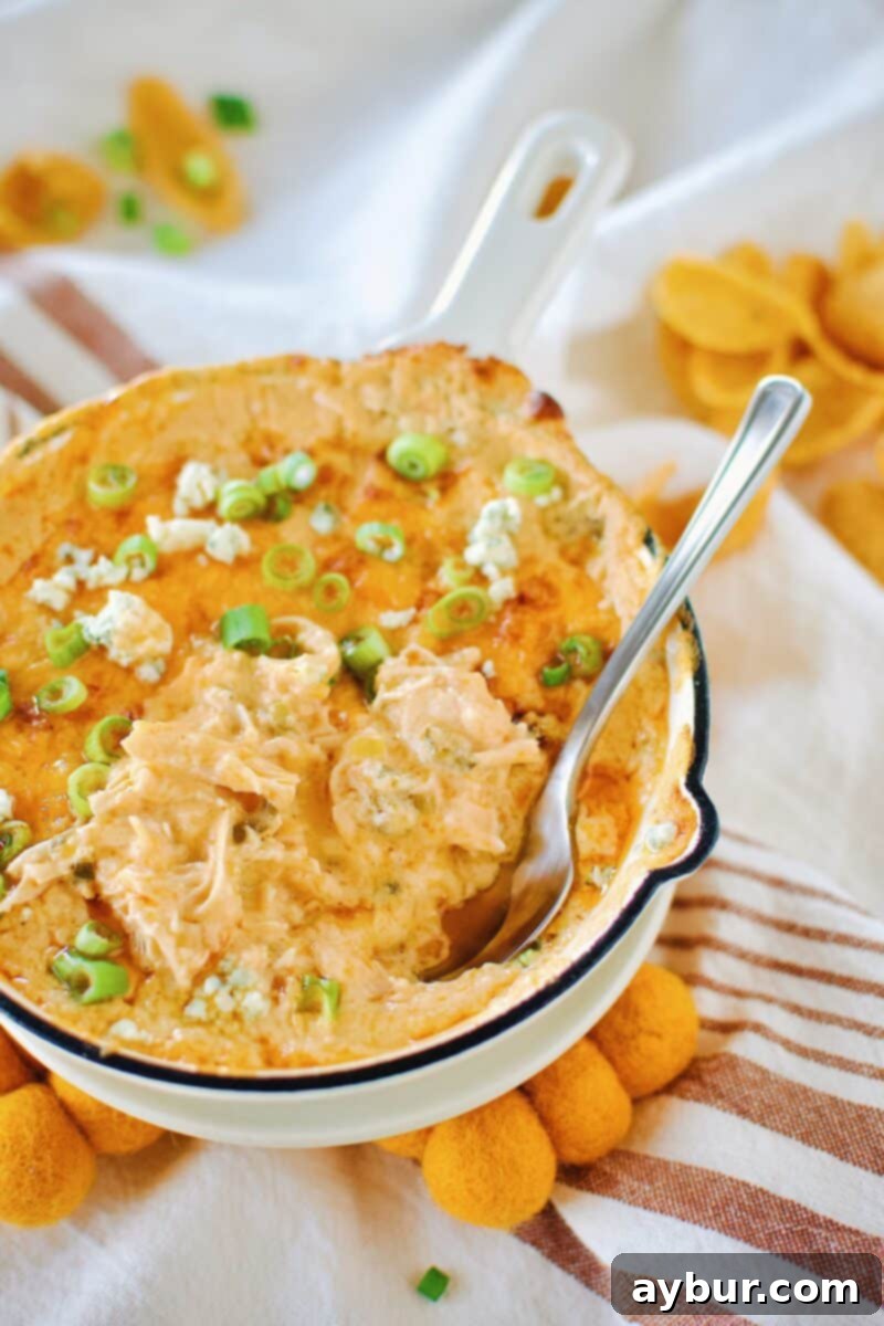 Close-up of baked Buffalo Chicken Cheese Dip in a baking dish
