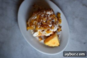 A creative cooling solution for Angel Food Cake: an unfooted tube pan is inverted over the neck of a wine bottle, allowing the cake to cool without collapsing and maintain its airy structure.