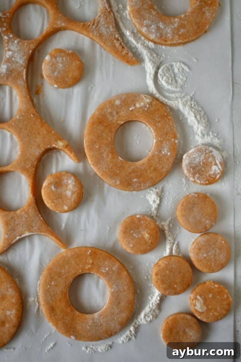 Cutting out donuts after rolling out dough.