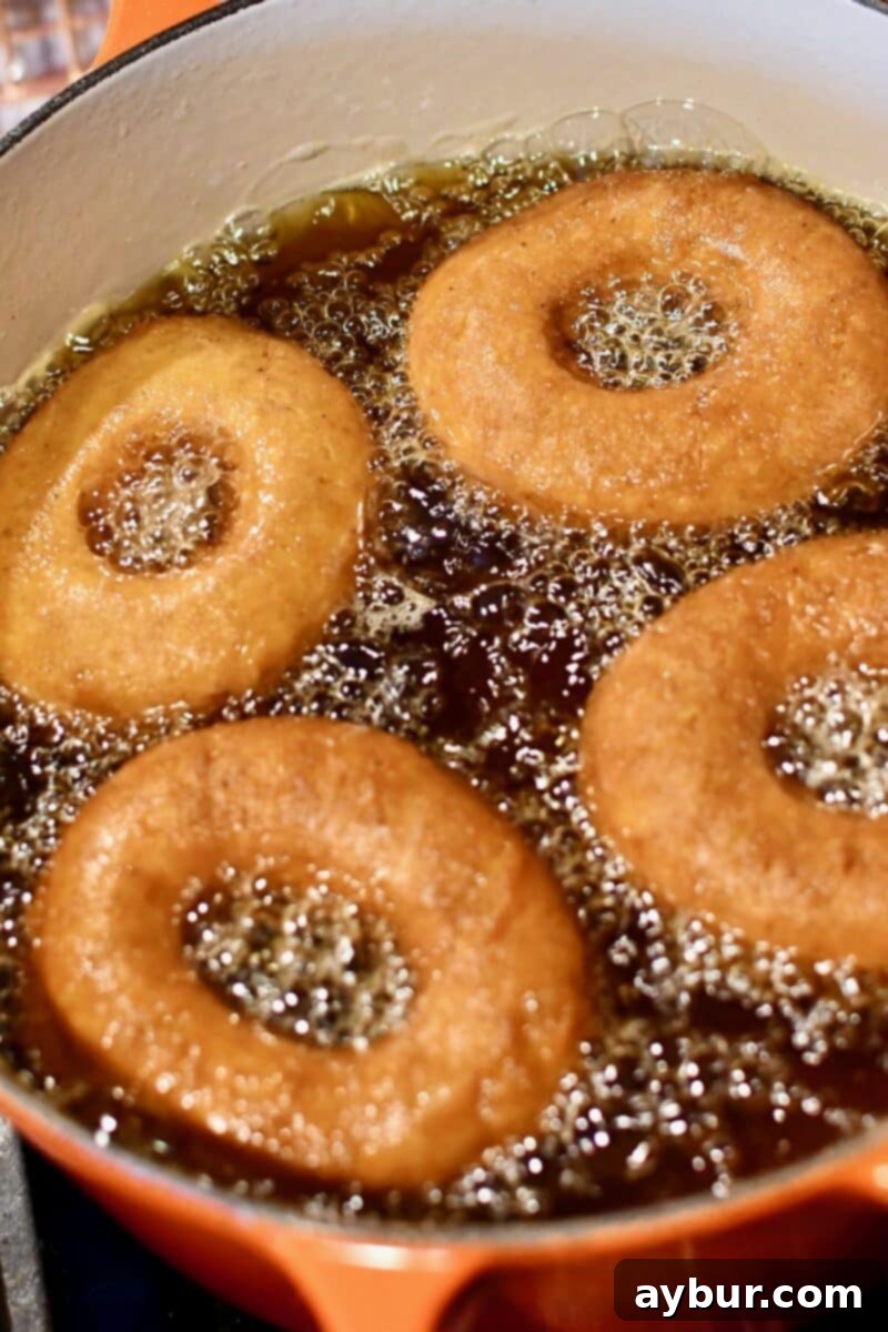 Donuts frying in hot oil.
