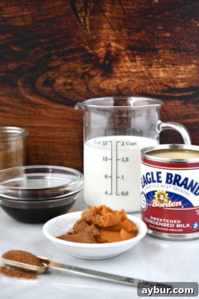 Pumpkin Spice Creamer 4 Essential ingredients for Homemade Pumpkin Spice Coffee Creamer laid out on a wooden table