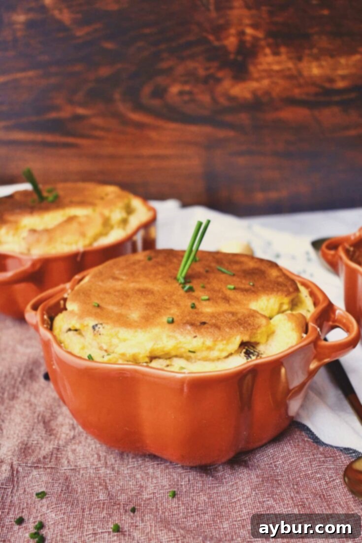 Pumpkin Goat Cheese Soufflé ready to serve, garnihsed with fresh chives