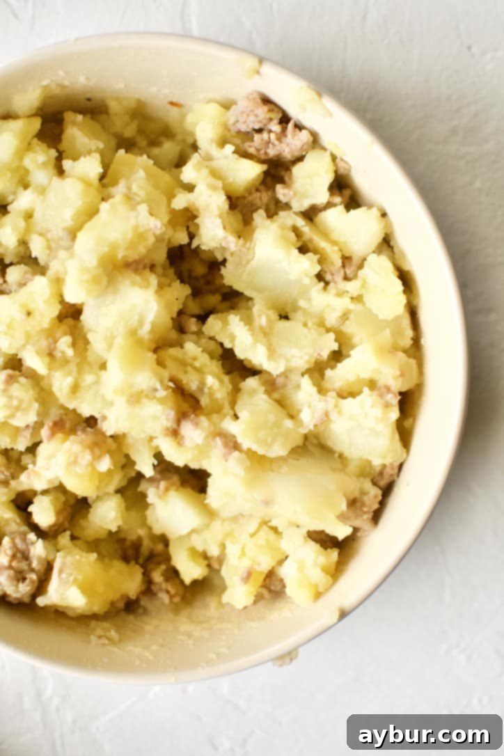 Chef's Signature Zuppa Toscana 8 Mashed Yukon Gold potatoes in a bowl, prepared to be returned to the soup as a natural thickener.