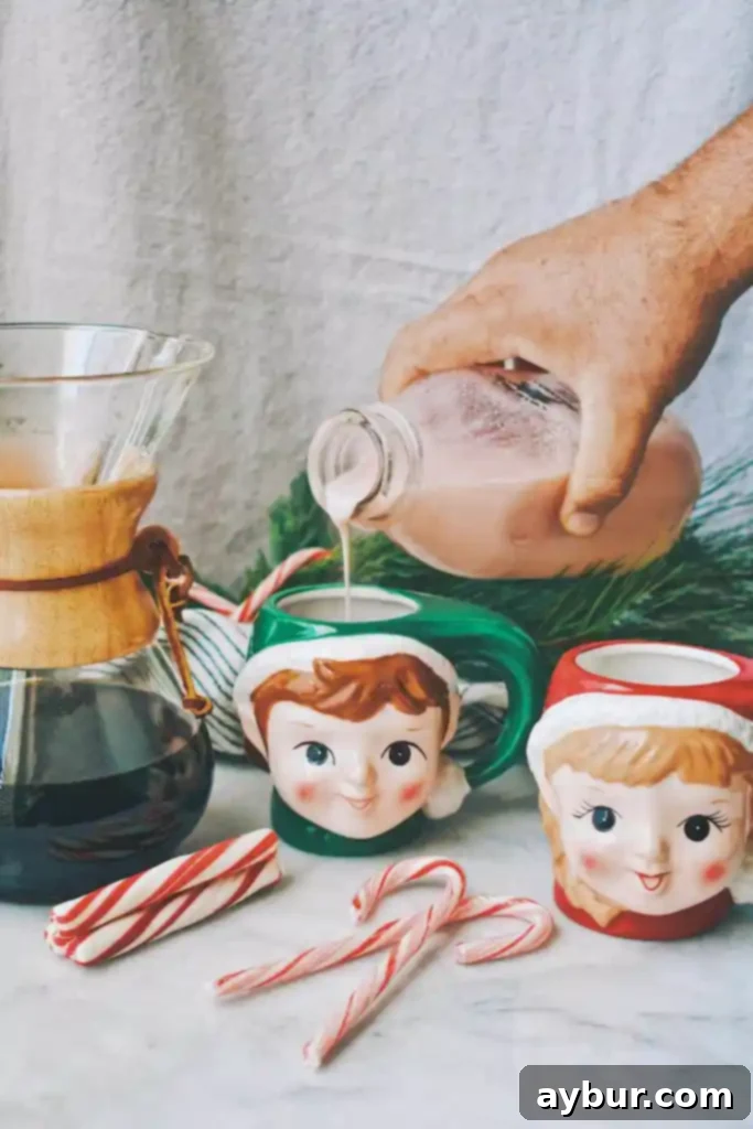 Peppermint Stick Coffee Creamer 3 A hand dressed as Santa pouring homemade Candy Cane Coffee Creamer into a mug of coffee.