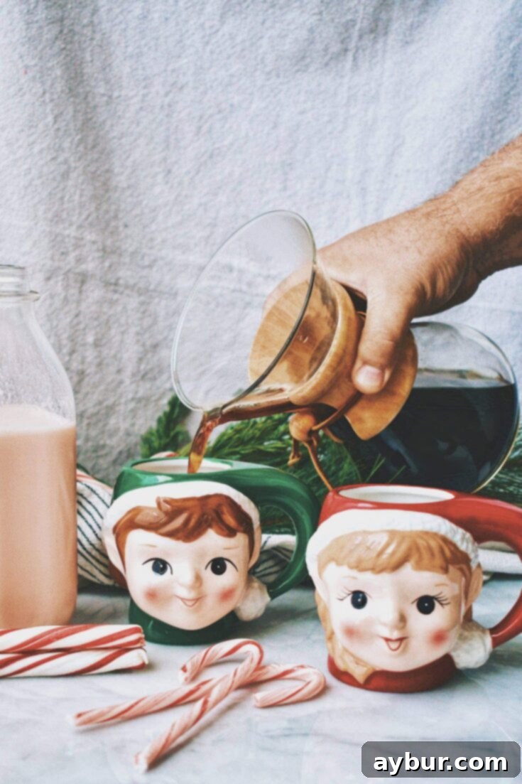 Candy Cane Coffee Creamer in a mug, garnished with a mini candy cane.