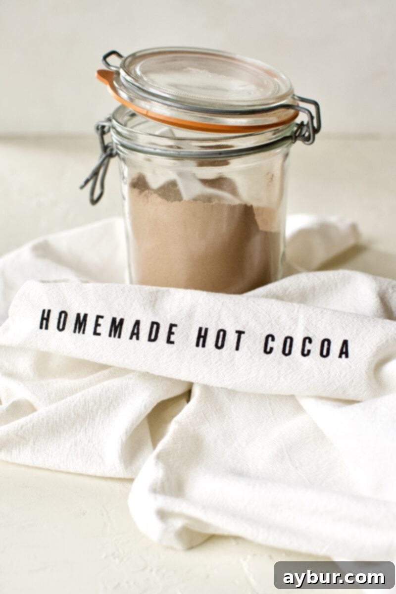 Sweetened-Free Cocoa Delight 2 Sugar-Free Hot Cocoa Mix in a jar with a tea towel around it.