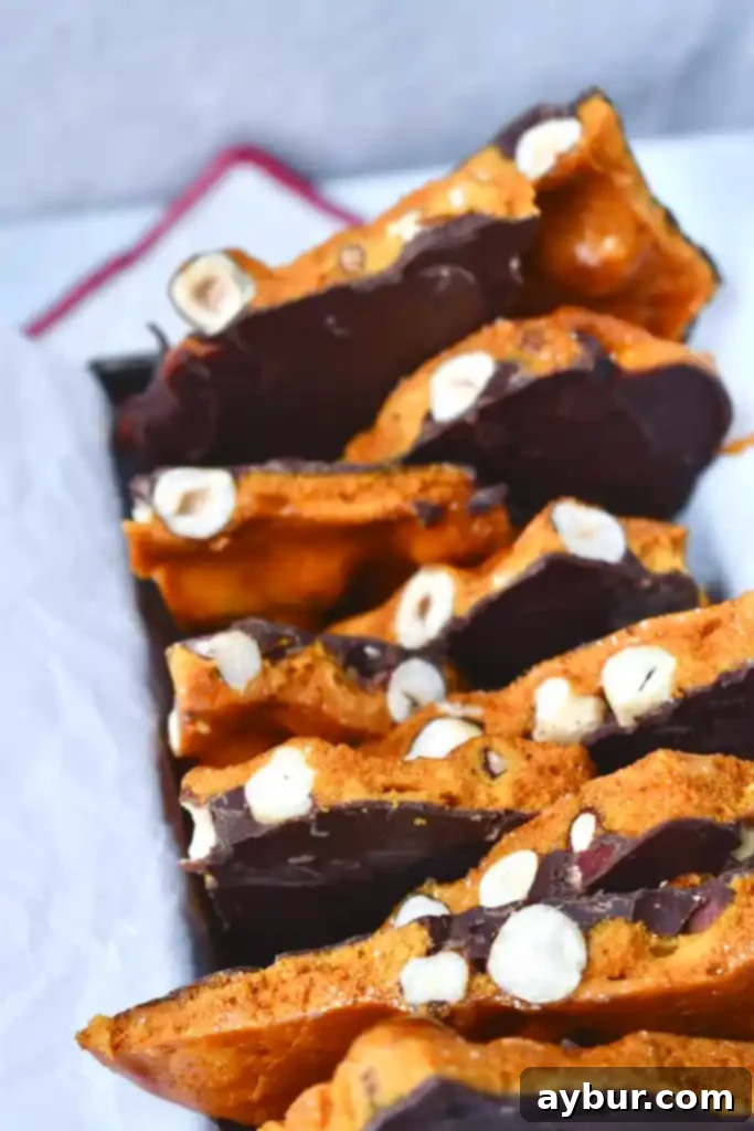 Homemade Honeycomb with hazelnuts cooling on parchment paper.